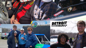 Several students smile at a race track. Logos read, "Michigan Planners: 60th Anniversary" and "Detroit Student Race Team."
