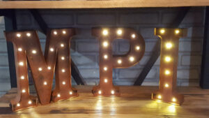 Metal letters M, P, and I light up in the Michigan Planners office.