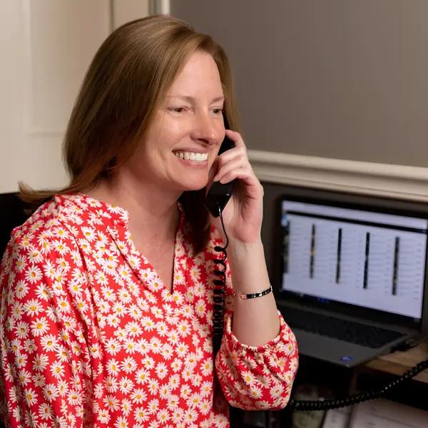 A Michigan Planners team member speaks with a client on the phone.