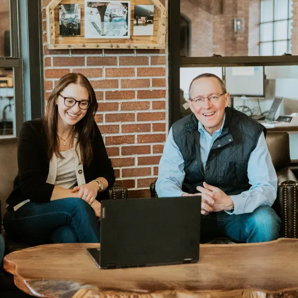 Two members of the Michigan Planners team smile while working together at the office.