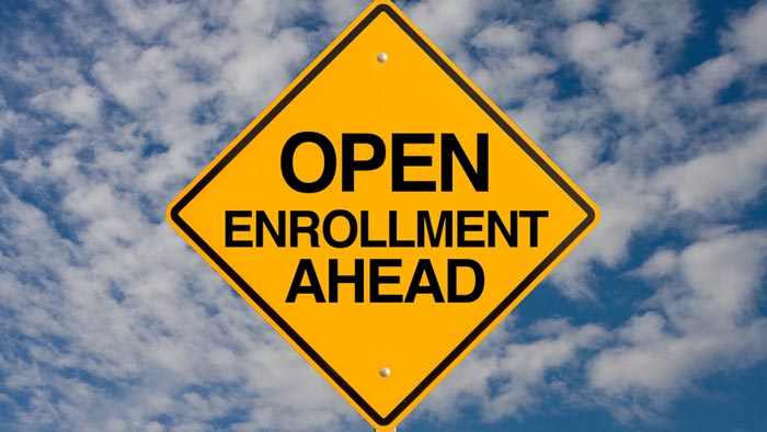 A road sign reads, "Open enrollment ahead."