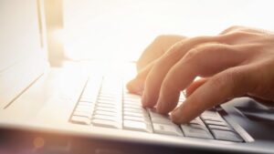 Someone types on a laptop.