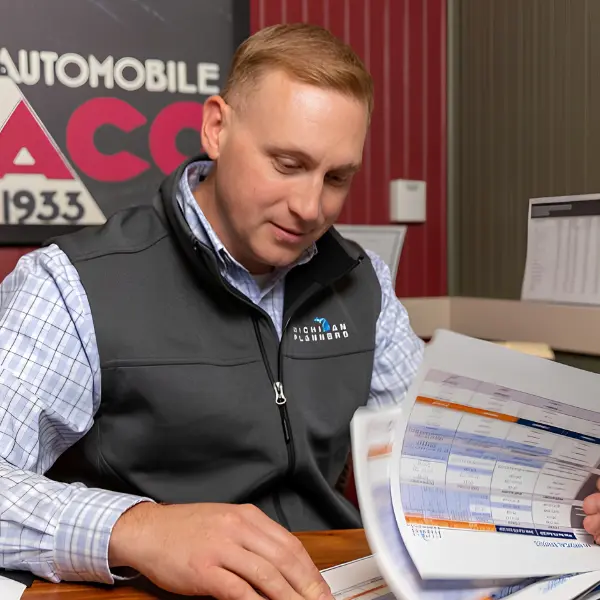 A Michigan Planners team member looks through paperwork.