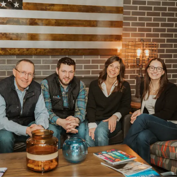 Four members of the Michigan Planners team pose together at the office.