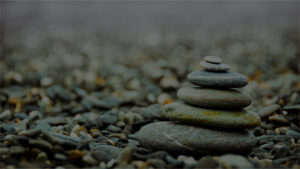Six rocks are stacked on top of each other in a style reminiscent of a zen garden.