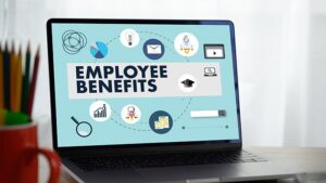 A laptop screen reads, "Employee Benefits."