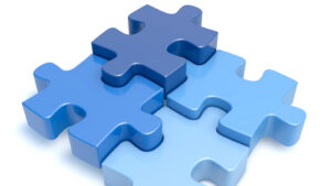 Four blue puzzle pieces fit perfectly together.