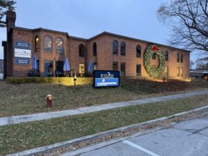 Michigan Planners has a massive Christmas wreath on the side of its building.