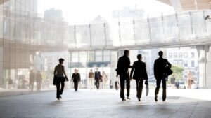Several people walk through a conference center.