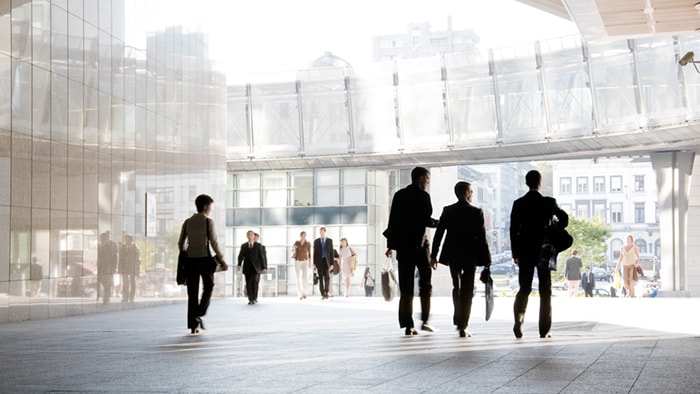 Several people walk through a conference center.