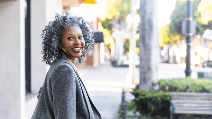 A woman in her sixties smiles.