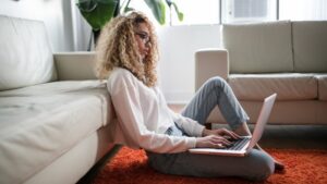 A young professional navigates insurance on her laptop.