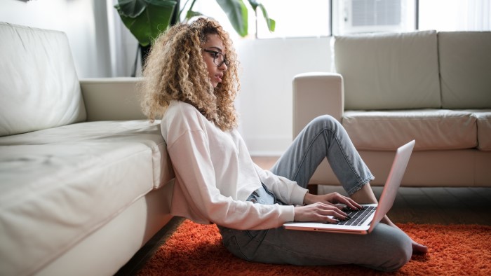 A young professional navigates insurance on her laptop.