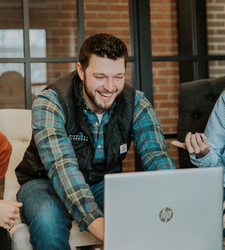 A Michigan Planners team member laughs while working.