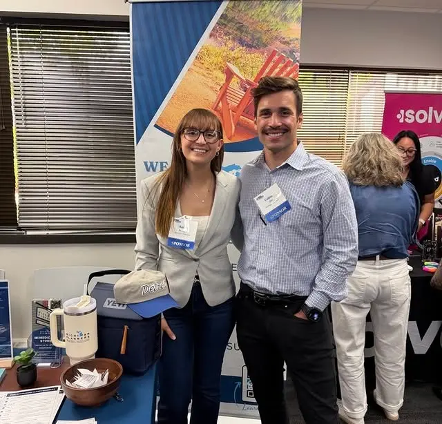 Two members of the Michigan Planners team smile at an event.