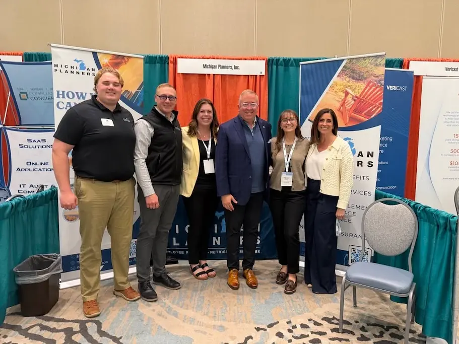 The Michigan Planners team poses together at an industry event.